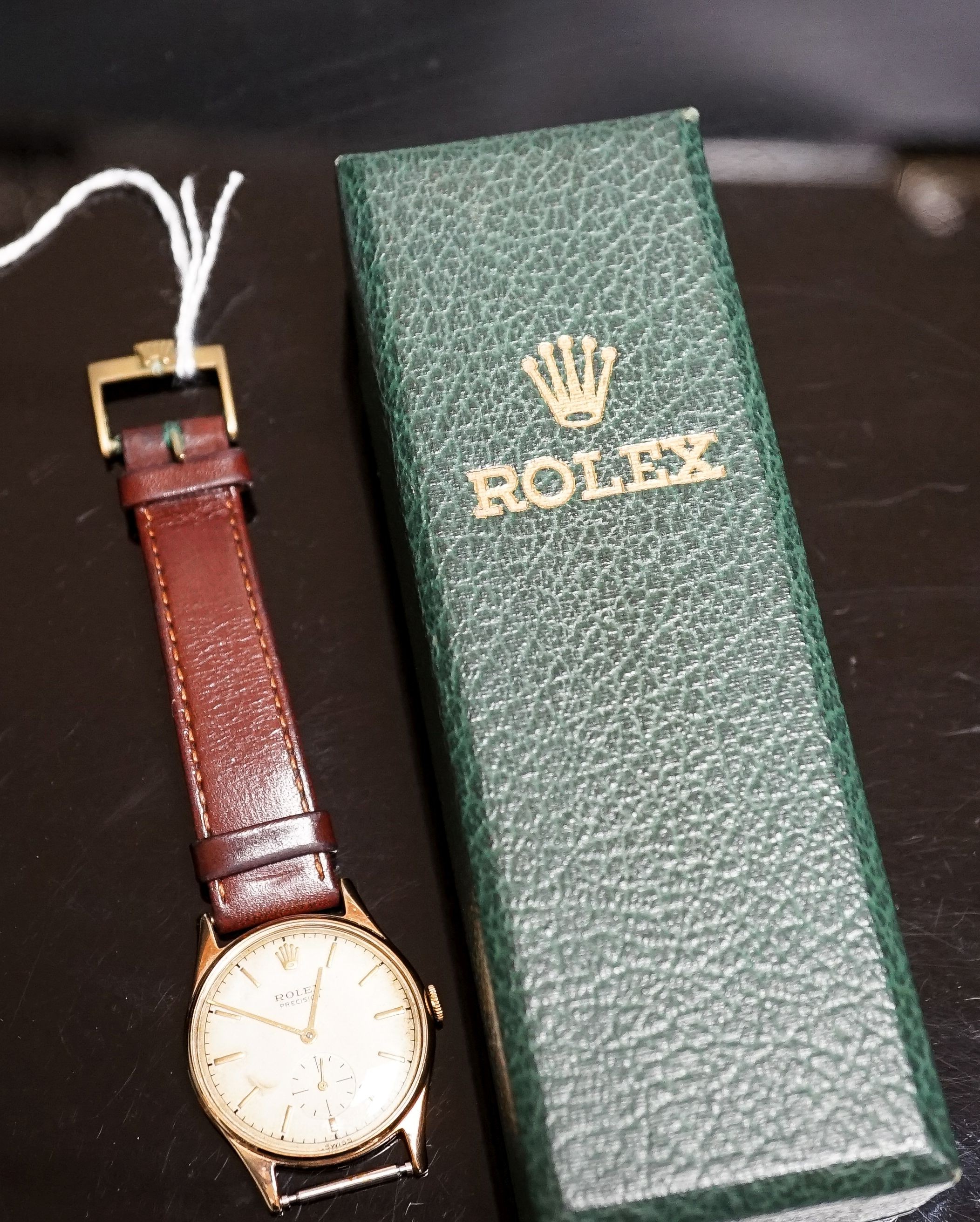 A gentleman's late 1950's 9ct gold Rolex Precision, manual wind wrist watch, on associated leather strap, with box and purchase receipt dated 3/8/1959, cased diameter 31mm, gross weight 28.5 grams, part of strap detached